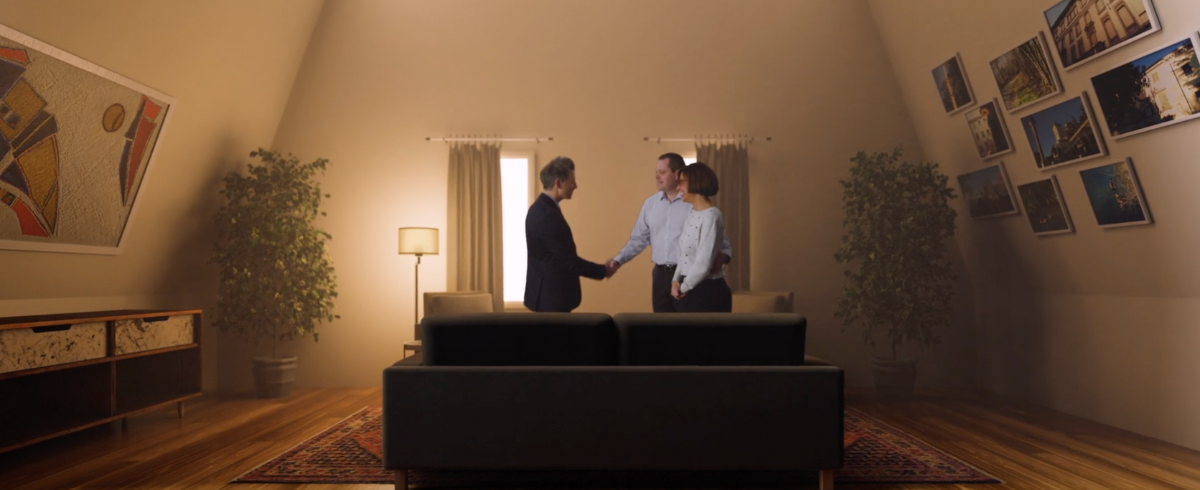A real estate agent shakes hands with a husband and wife, indicating that the house has already been sold.