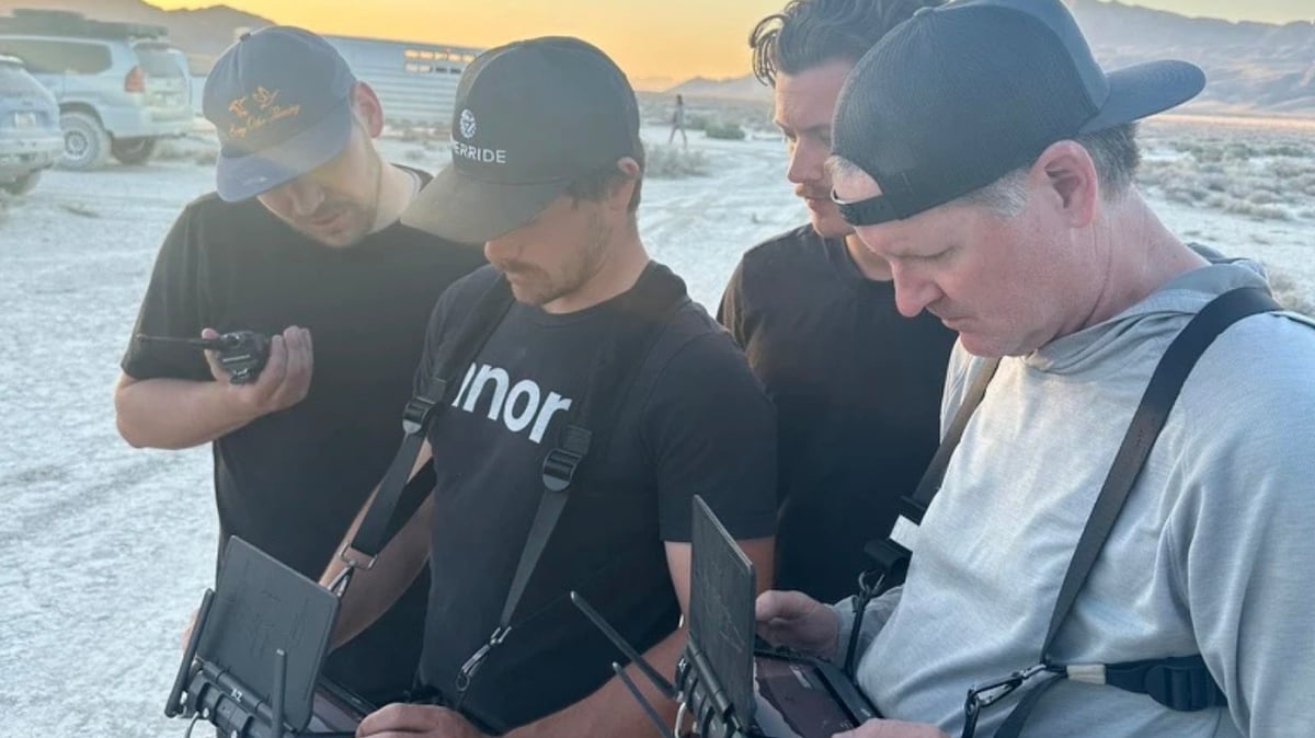 Crew members review footage together on set of the Porsche Mirage desert shoot