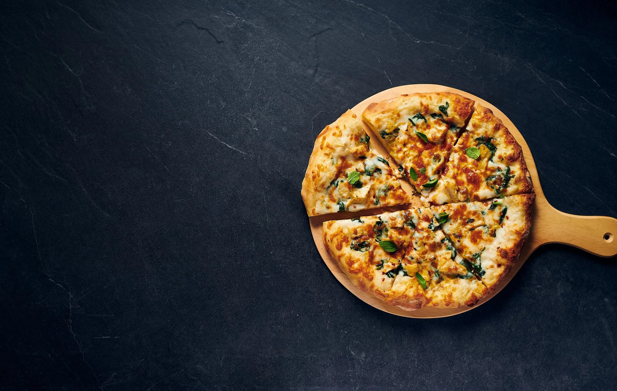  Photo of pizza on pizza handle with blackboard background