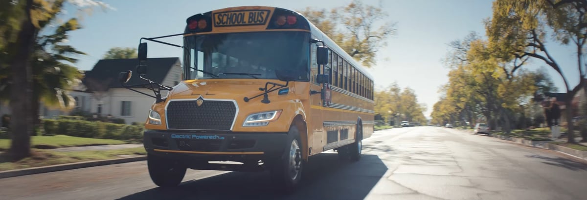 A front view of a yellow school bus in motion