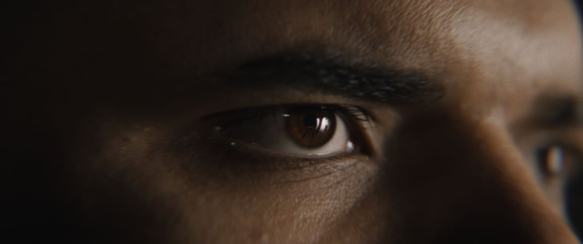 A close-up image capturing a man's eye, vividly expressing strong emotions
