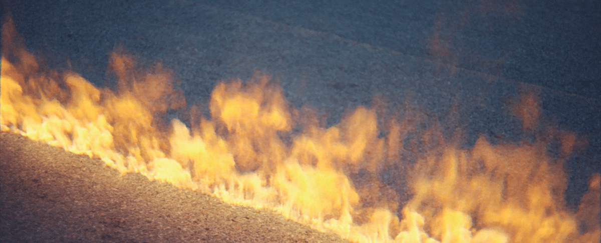 A flame trail left behind by a passing motorcycle.