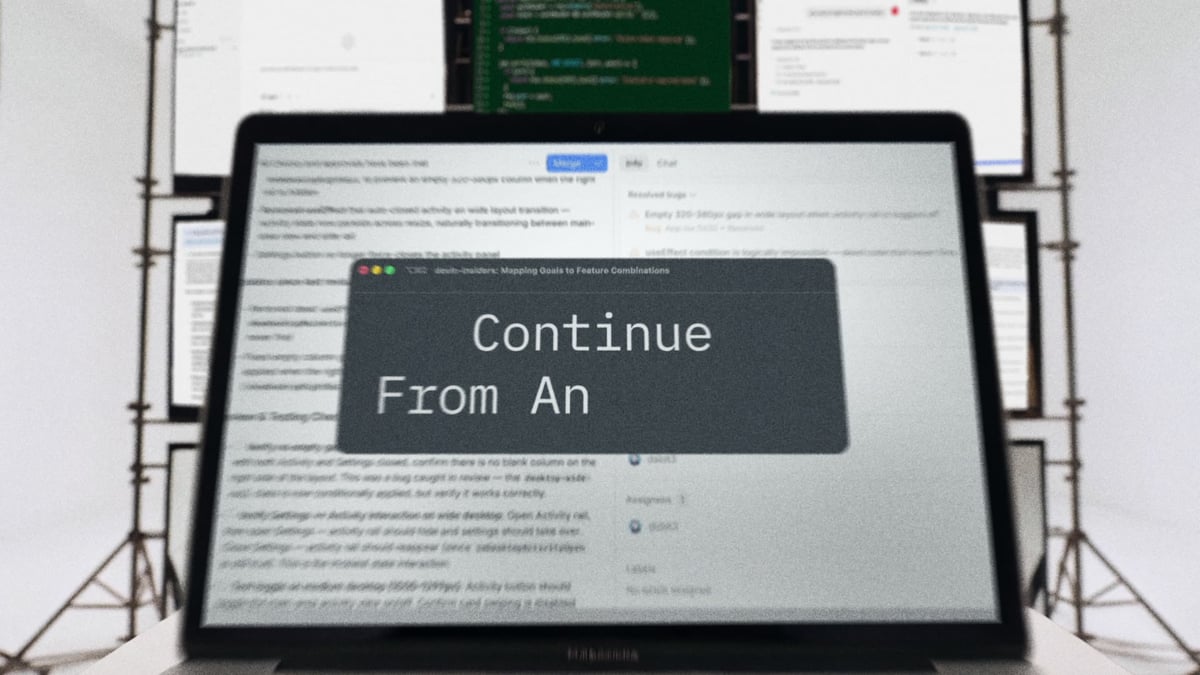 Tight push-in on a laptop screen as a terminal modal types out "Continue From An—" mid-keystroke, scaffolding rigs and reference docs softly defocused behind it.