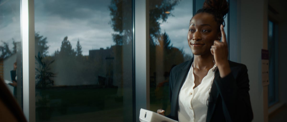 A woman holding a device used for identity verification.