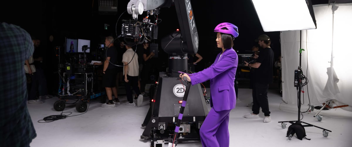 The actress is on the set, in a scene where she is riding a scooter.