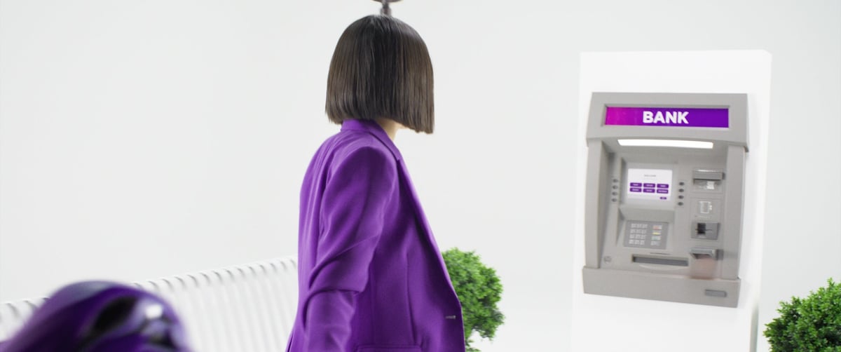 A woman is approaching the ATM.