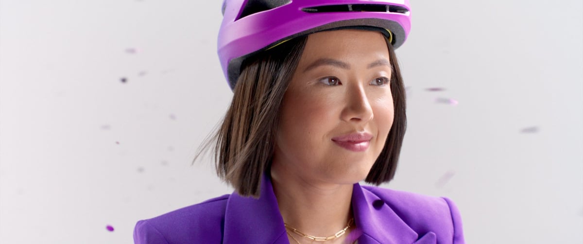A close-up image of the helmeted woman, showcasing her beauty.