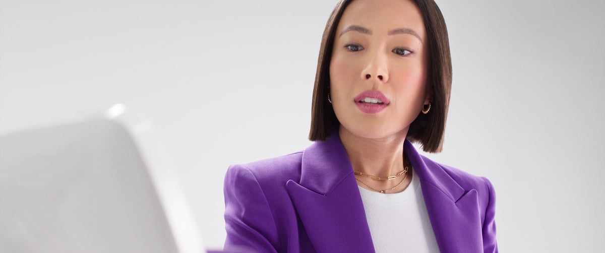 The woman wears a worried expression as she anxiously waits for the result of the mobile transaction.