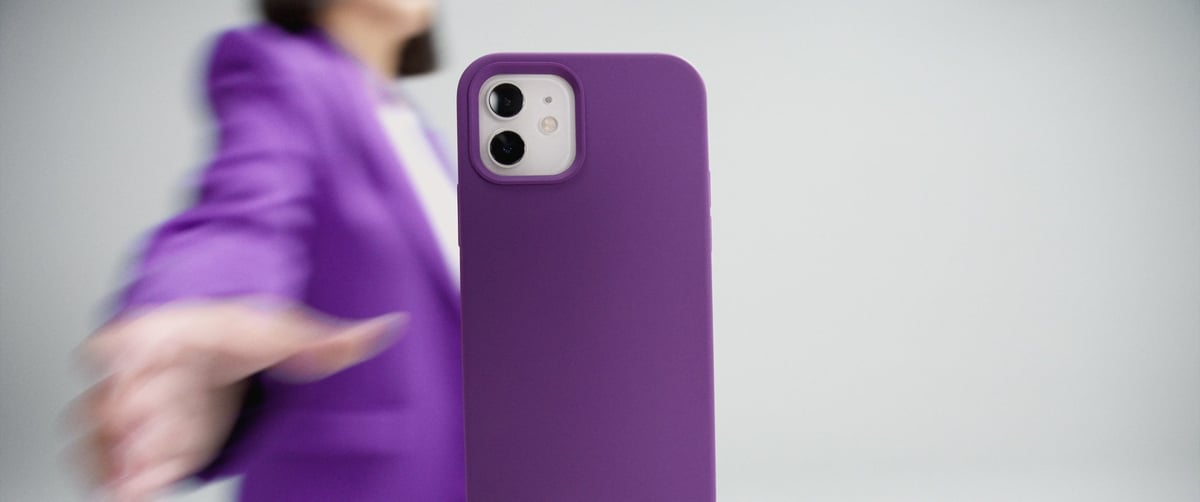 The woman swiftly snatches the phone that was suspended in the air.