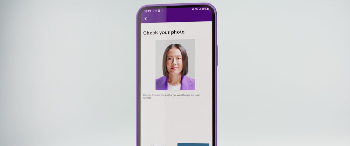 A mobile phone hangs in mid-air, displaying a picture of the woman.