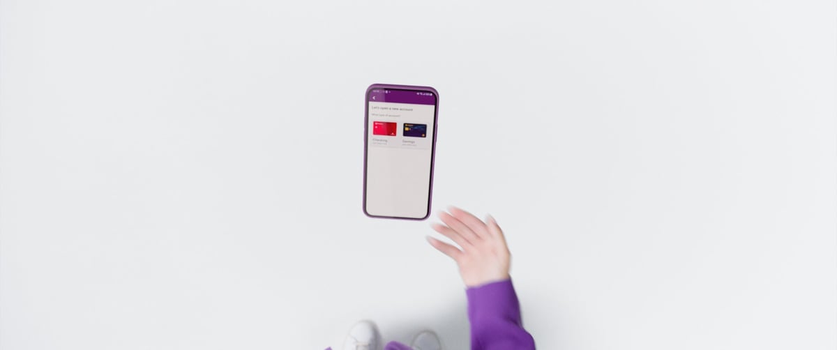A mobile phone hovers in the air as a hand releases its grip.