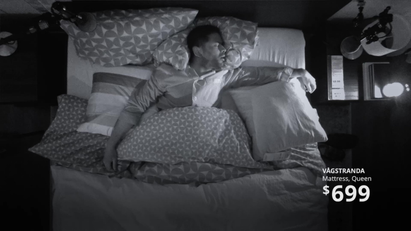A sleeper rests soundly under night vision in a real IKEA showroom, surrounded by a rig of microphones capturing every murmur.