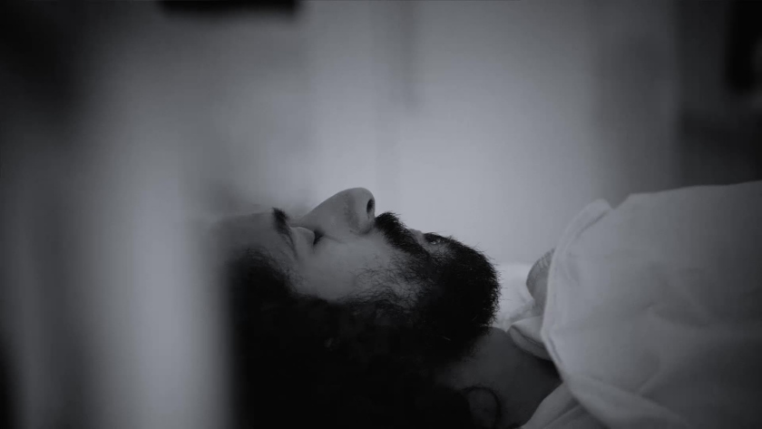 A cinematic close-up shows a participant in deep rest, as the night vision camera rolls on.