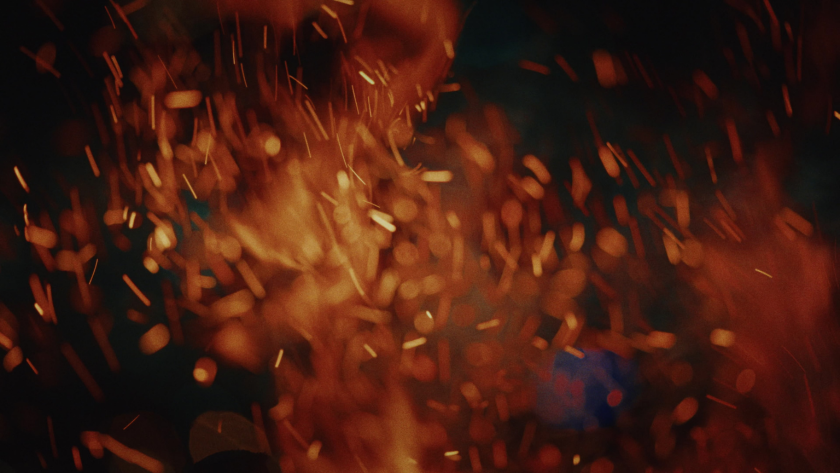 Sparks fly in the darkness, captured in slow motion to underscore danger, intensity, and action.