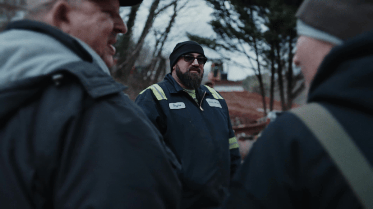 The driver connects with volunteers and locals during a moment of conversation and shared purpose on site.