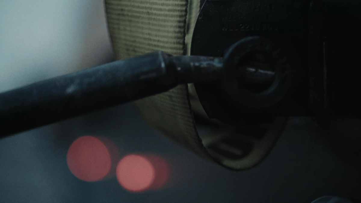 A macro detail shot of a ratchet strap locking into place emphasizes the tactile, technical precision of truck prep.
