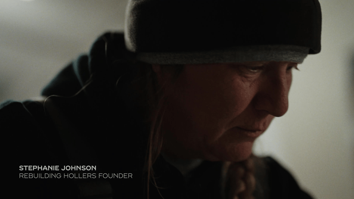 A close-up of Stephanie Johnson shows quiet determination, capturing the emotional weight behind her community mission.