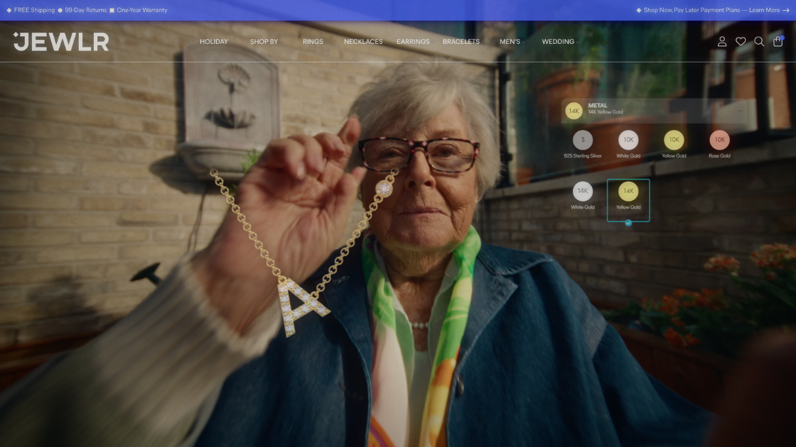 A grandmother wearing glasses, browsing jewelry on the Jewlr website.