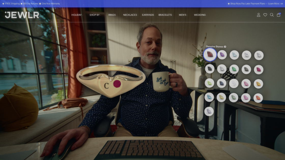A bearded father holding a mug while browsing jewelry on the Jewlr website.