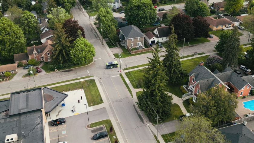 Overhead view of a Ride Argo bus driving through a quiet residential neighborhood.