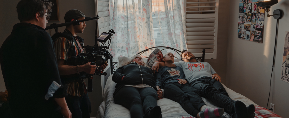 The crew in action, capturing scenes of the leukemia patient and her family lying in bed together.