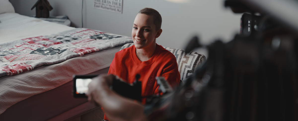 The beautiful face of the leukemia patient, wearing an orange shirt, while being interviewed.