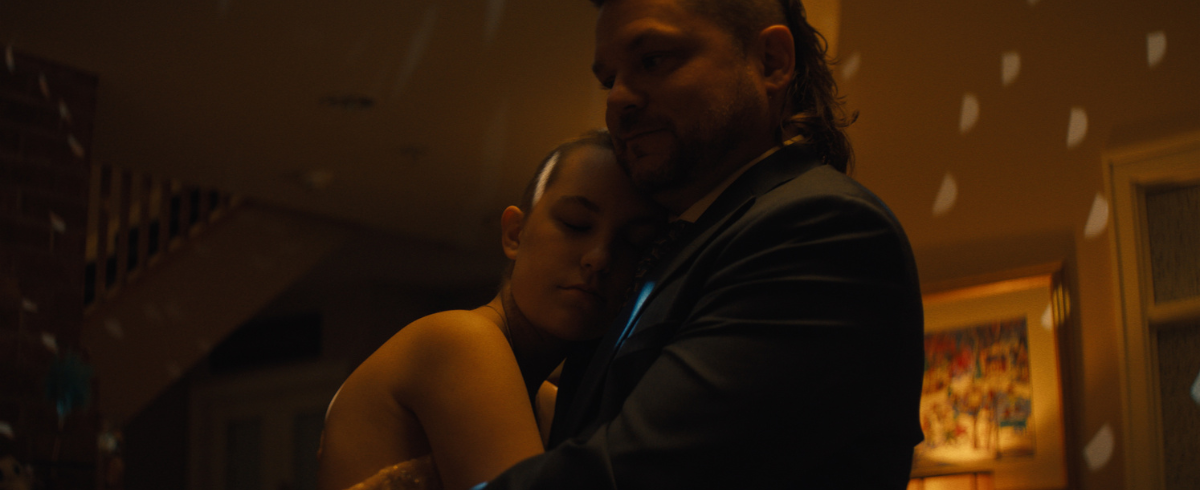 A close-up image of the leukemia patient wearing her prom dress and dancing happily with her dad.