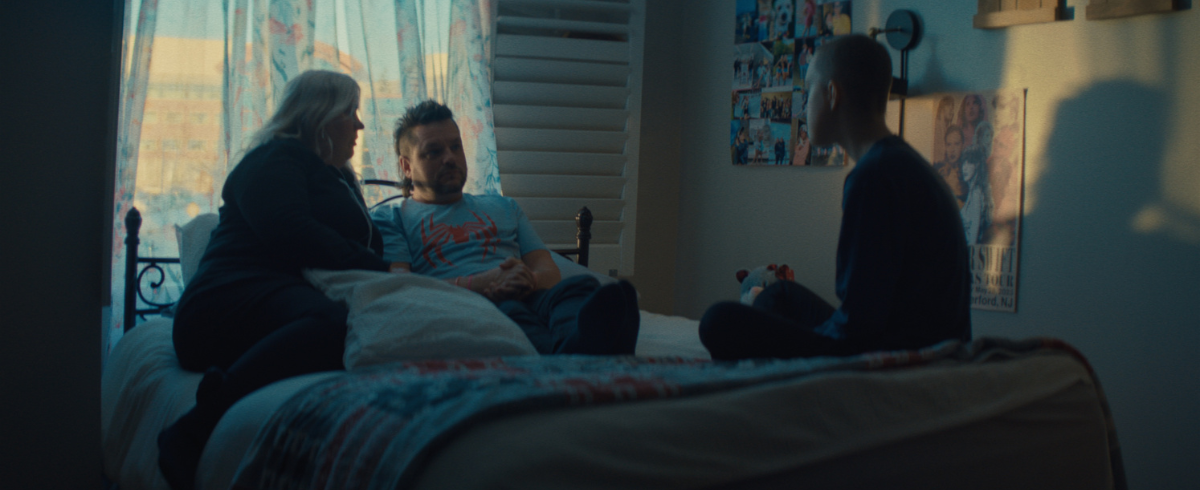 The leukemia patient seated in bed with her parents