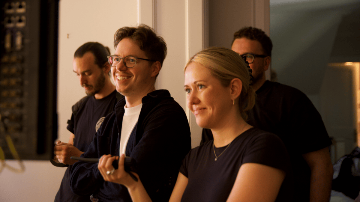 Director and producer smiling while watching the production on set.