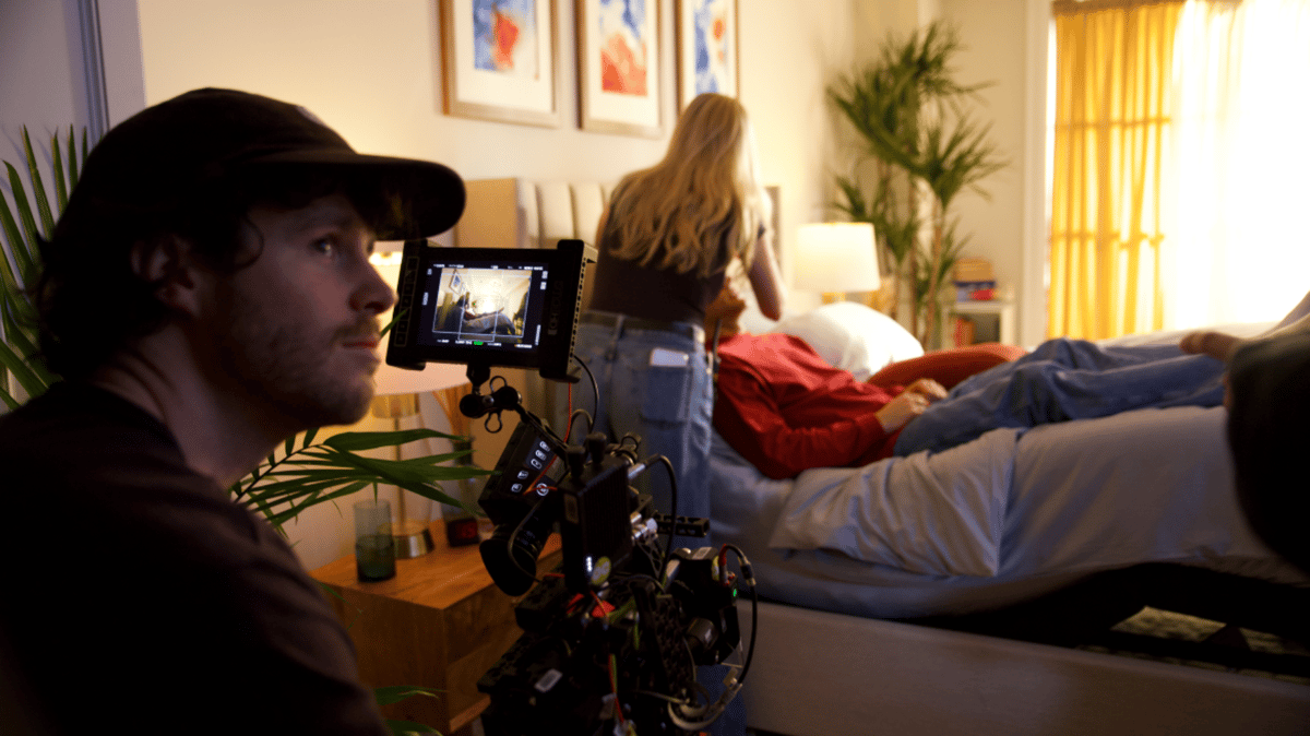 Makeup artist retouching the actor while on set.