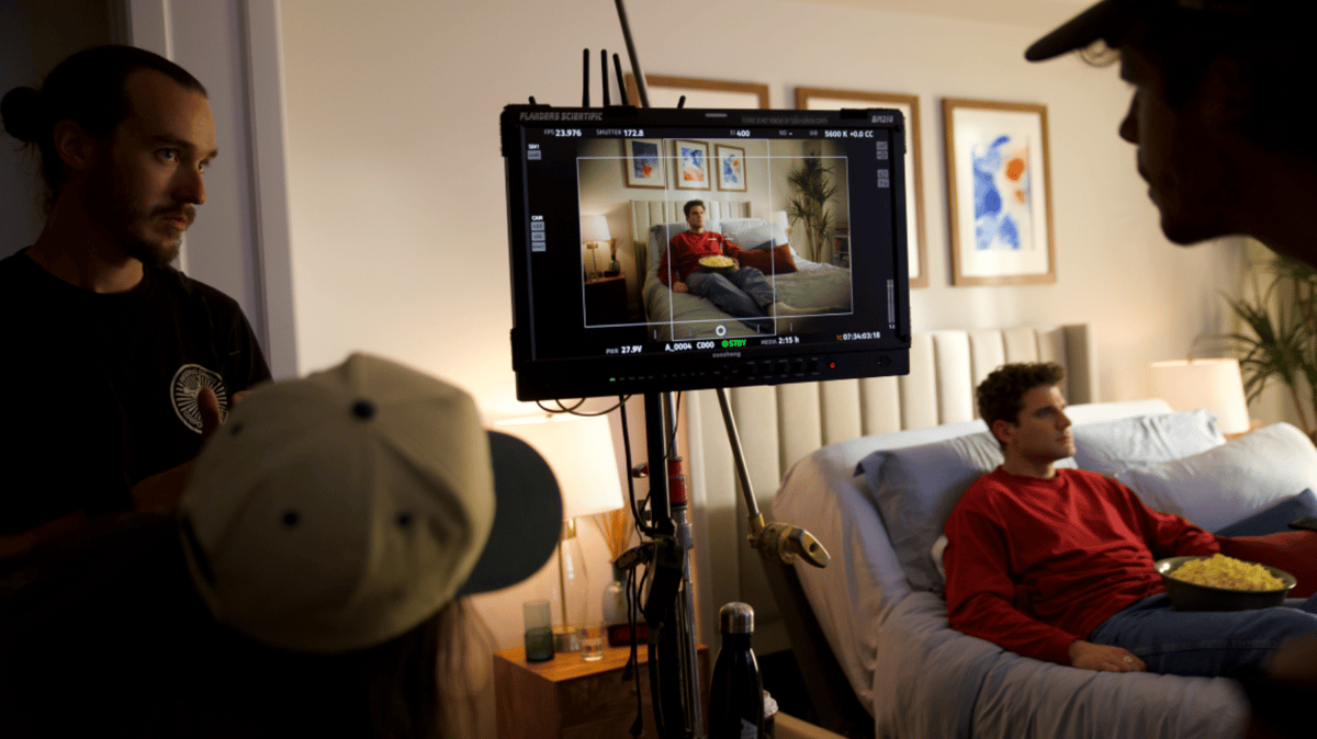 Production team watching the monitor while the actor is on set.