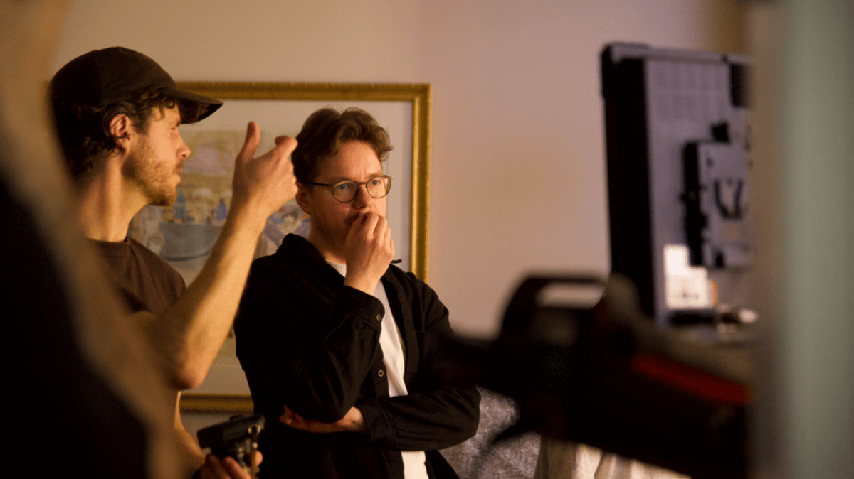 Director and videographer engaged in a discussion.