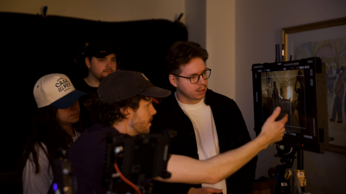 Production team setting up while monitoring the screen.