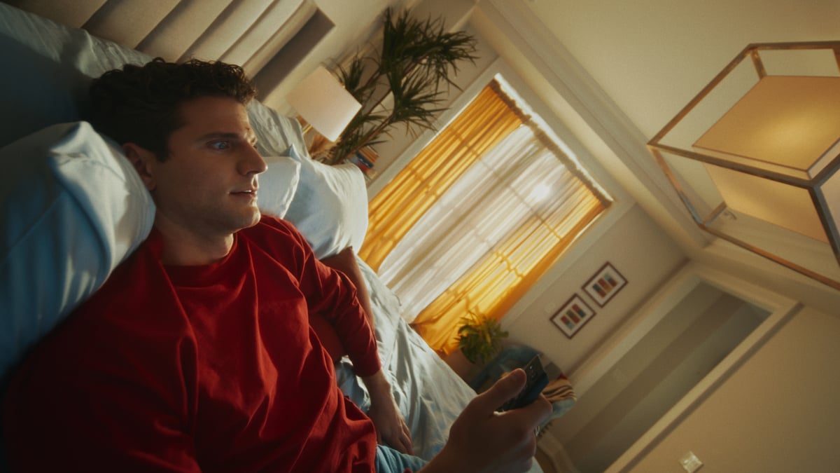 Man lying in bed, completely relaxed.