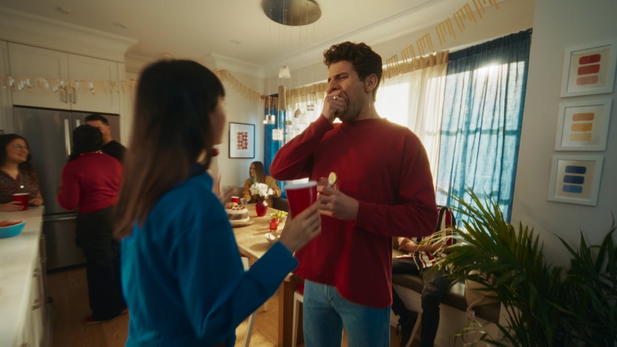 Man yawning and covering his mouth in front of a girl.