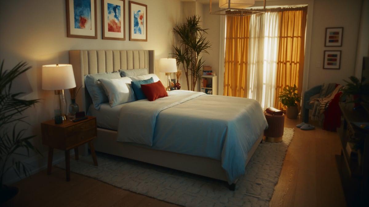 A room with a cozy, aesthetically designed bed.