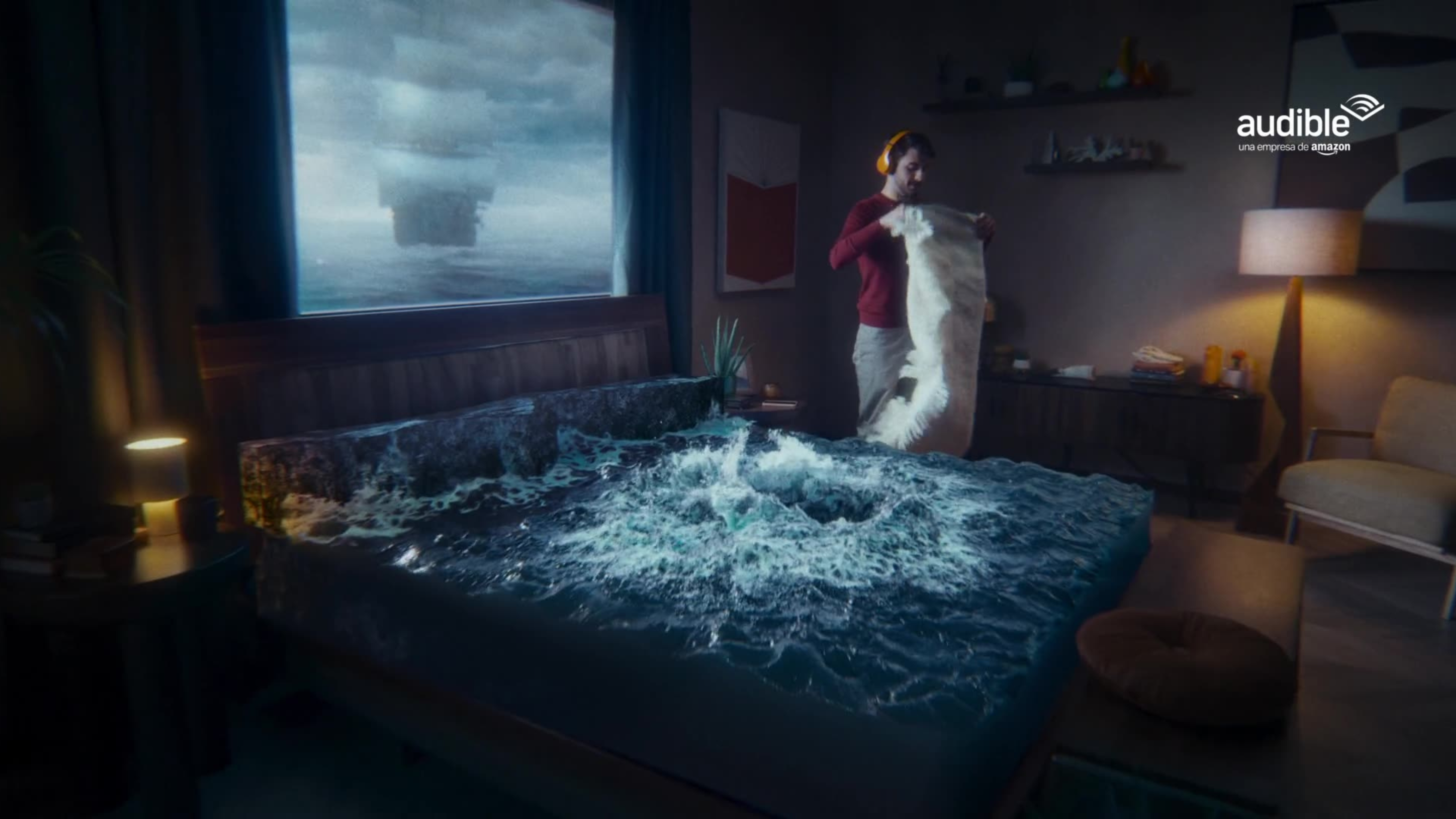 A man wearing headphones makes his bed while stormy ocean waves crash across the mattress in a surreal Audible ad.