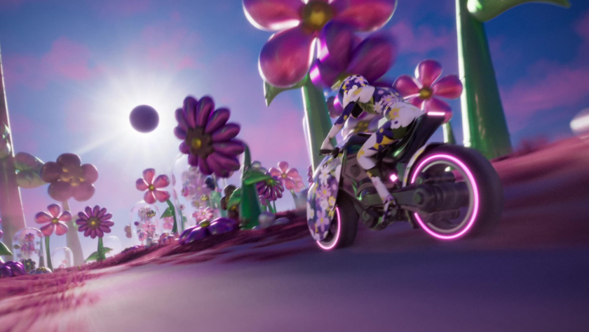 A futuristic biker clad in floral-patterned gear rides a motorcycle through a candy-colored field of oversized flowers under a dramatic sky. The playful, dreamlike landscape contrasts hyper-stylized motion with fantastical design—bringing a psychedelic, video game-like energy to life.