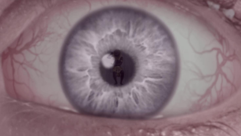 A close-up of an iris tinted in soft pinks and purples, with the silhouette of a person curled inside the pupil. This surreal image symbolizes introspection, memory, or the haunting presence of someone significant—blending intimate emotional depth with experimental visual storytelling.