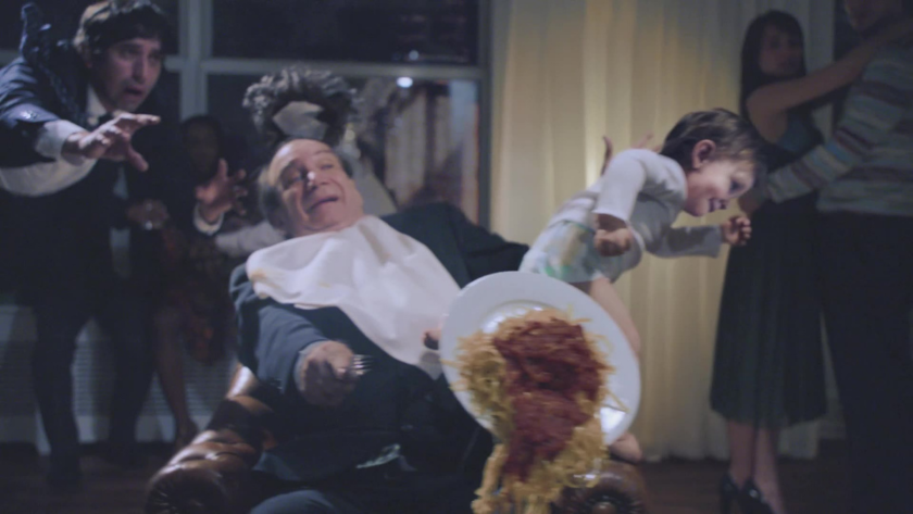 A flying toddler knocks over a plate of spaghetti in midair chaos, turning a family party into a moment of hilarious mayhem.
