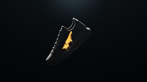 Photo of outline of a sneaker with fire burning on the inside. A dark shadow casts over the sneaker. Black background. 