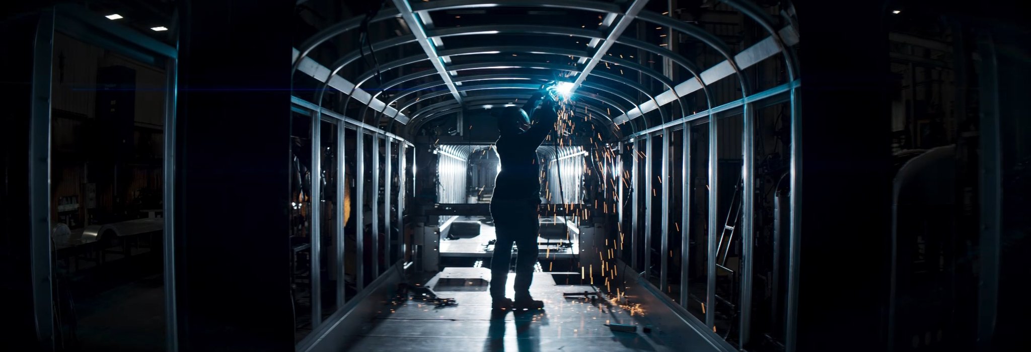 Welder working inside the truck, assembling the vehicle