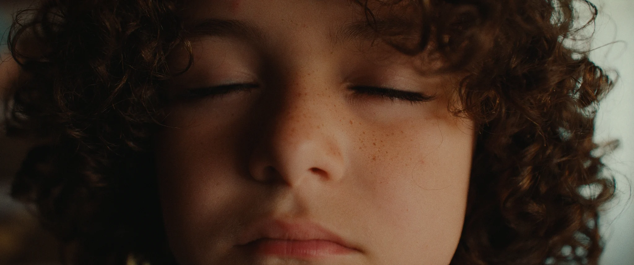 close up of a young boy closing his eyes